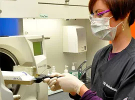 Staff member using the sterilization equipment